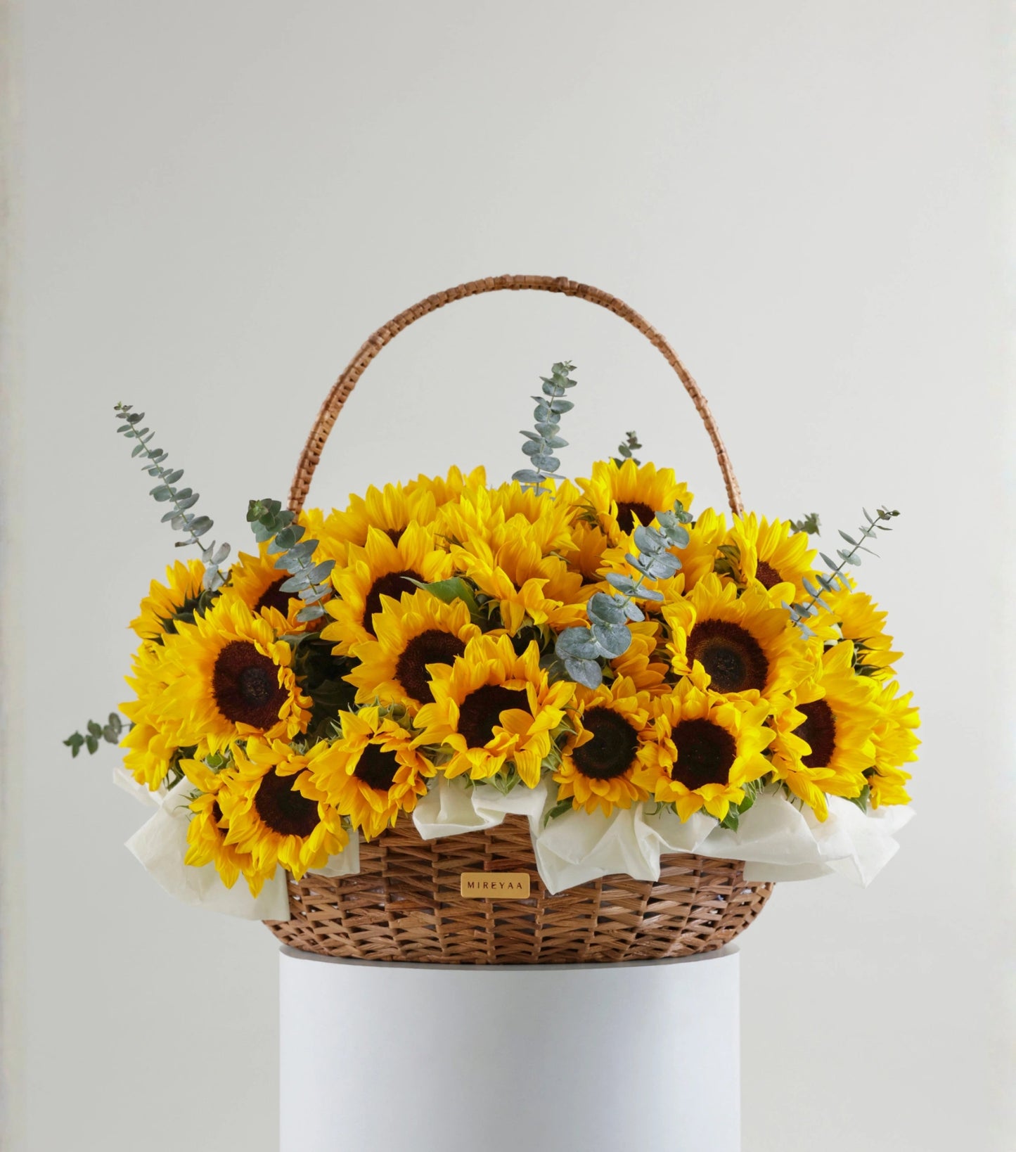 Front view of Grande size sunflowers in a water hyacinth estate basket — The Sunfield Estate Basket by Mireyaa, Mumbai same-day delivery