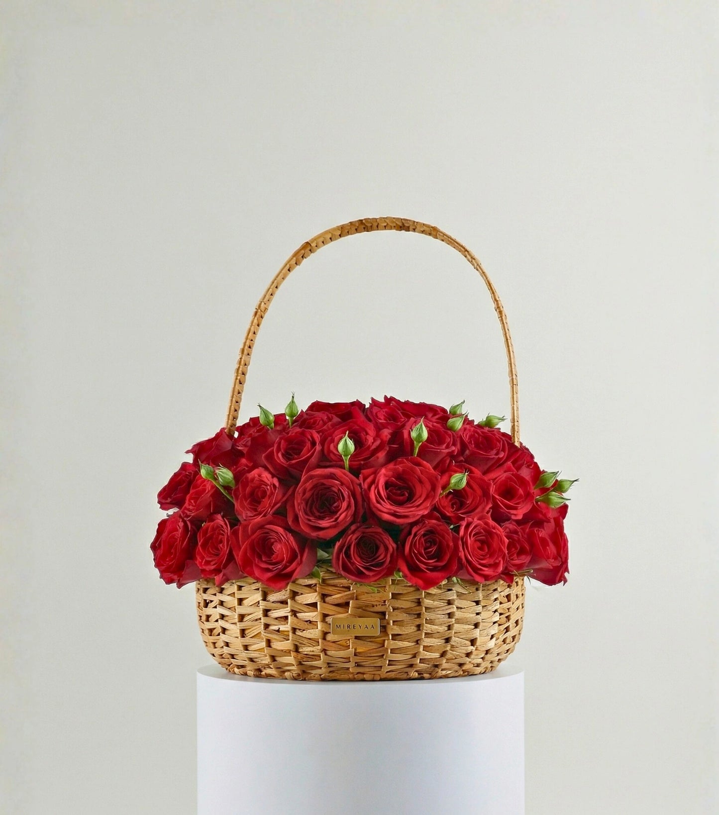 Front view of crimson red roses in a water hyacinth estate basket — The Grand Rose Estate Basket by Mireyaa, Mumbai same-day delivery
