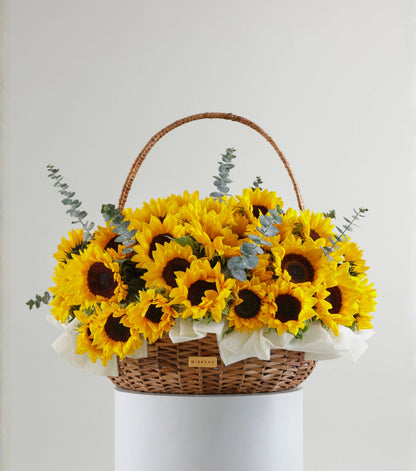 Front view of Grande size sunflowers in a water hyacinth estate basket — The Sunfield Estate Basket by Mireyaa, Mumbai same-day delivery