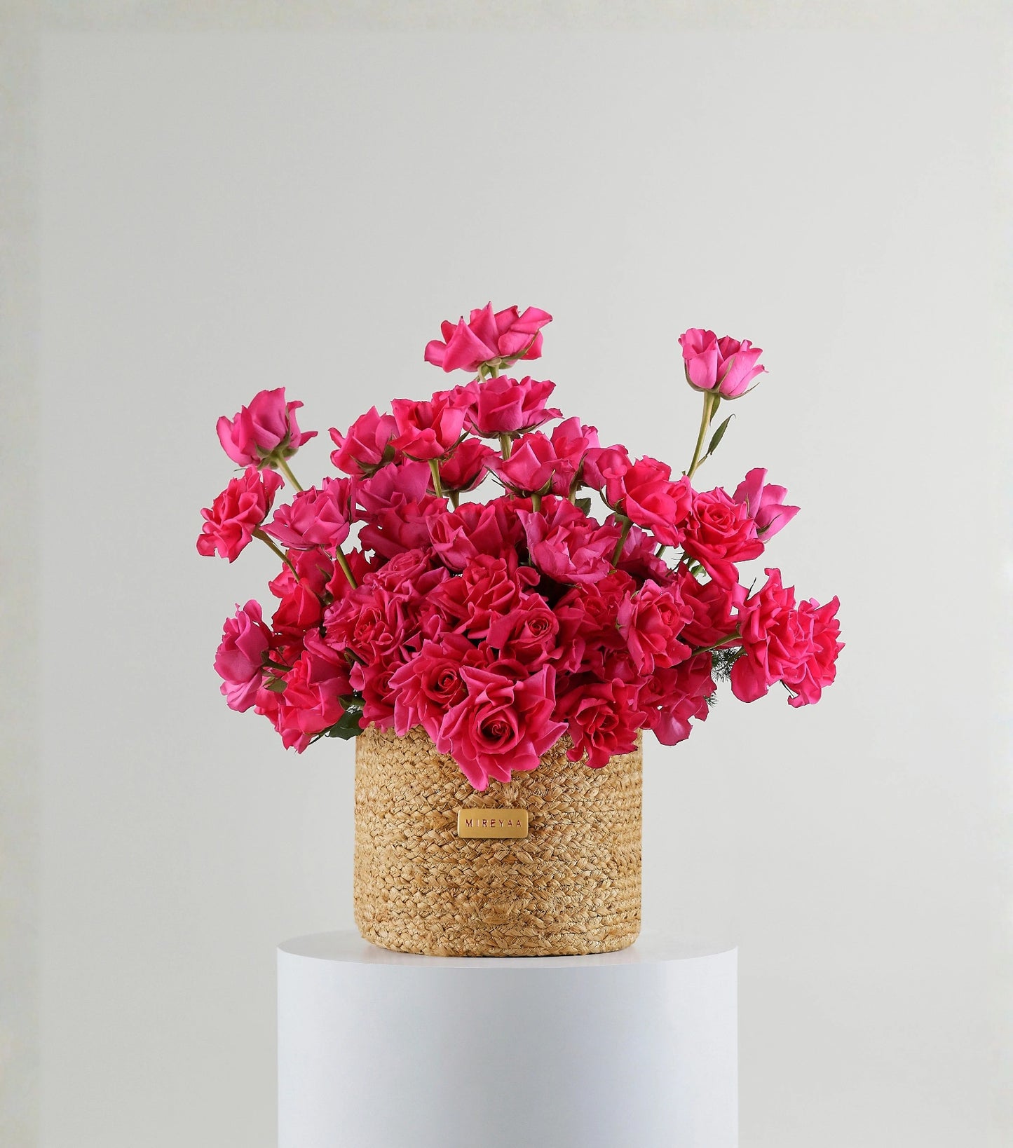 Front view of crimson red roses in a handwoven jute harvest basket — The Sculpted Crimson Harvest Basket by Mireyaa, Mumbai same-day delivery