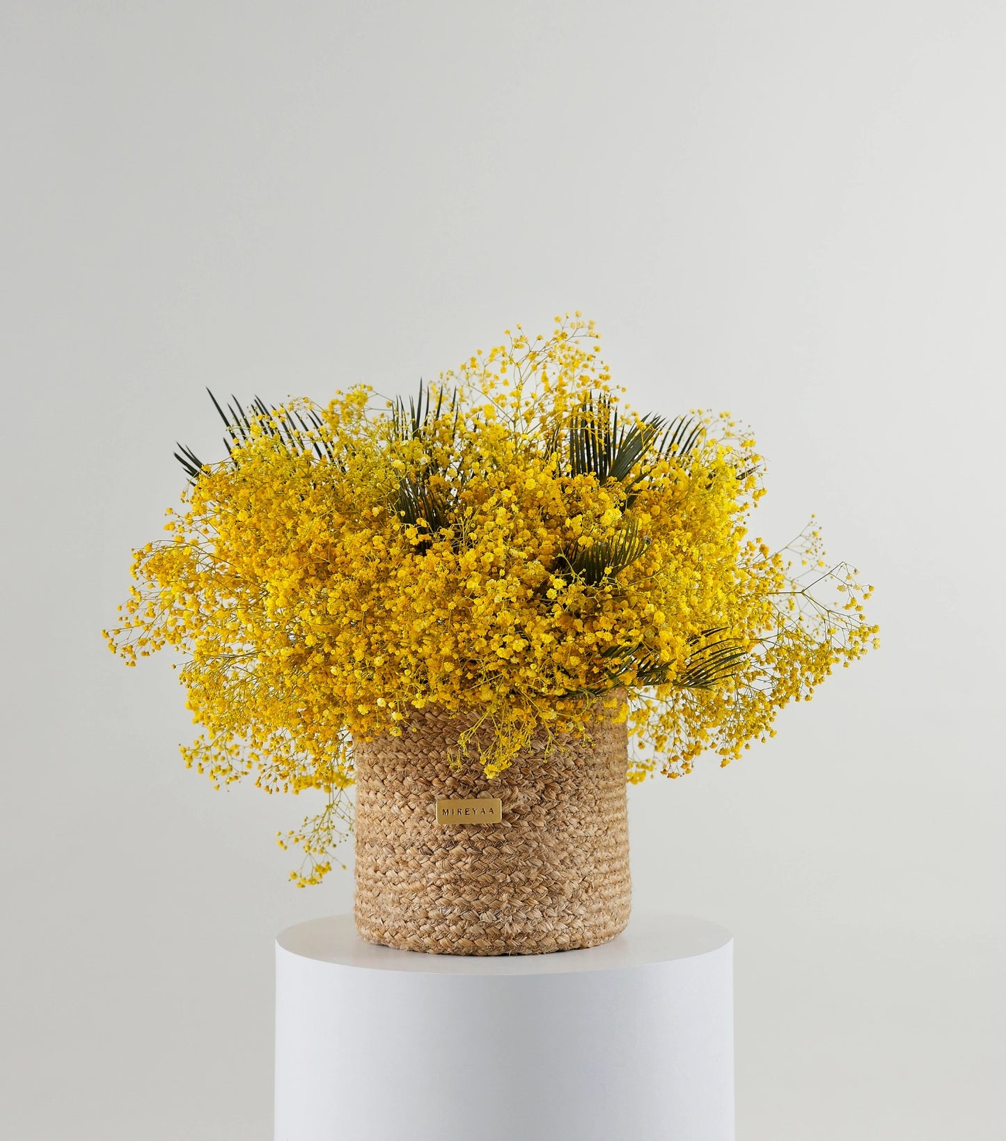 Front view of garden mix flowers in a handwoven jute harvest basket — The Golden Meadow Harvest Basket by Mireyaa, Mumbai same-day delivery
