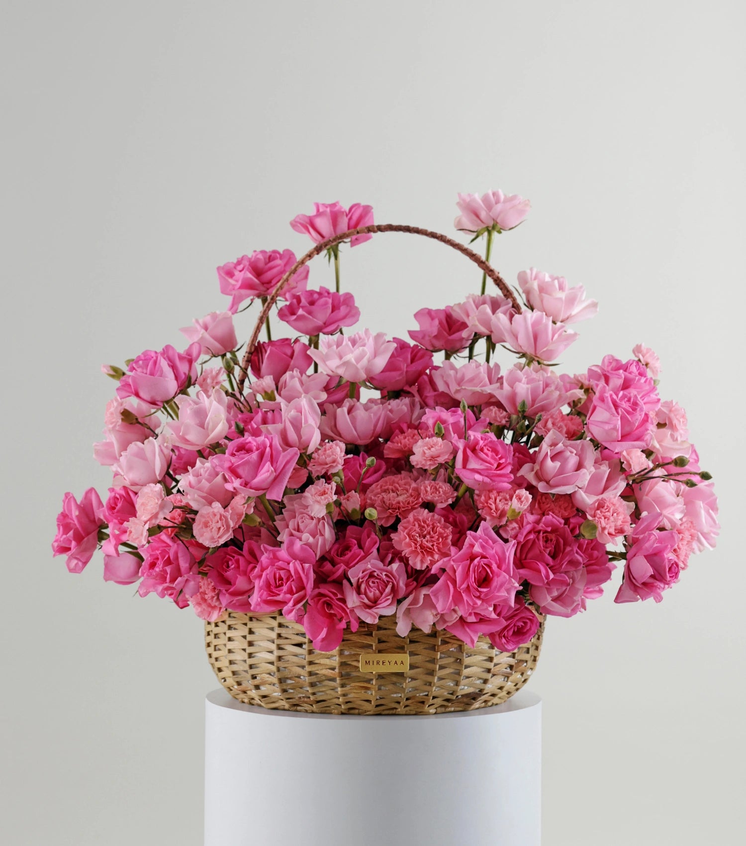 Front view of blush pink roses in a water hyacinth estate basket — The Petal Study Estate Basket by Mireyaa, Mumbai same-day delivery