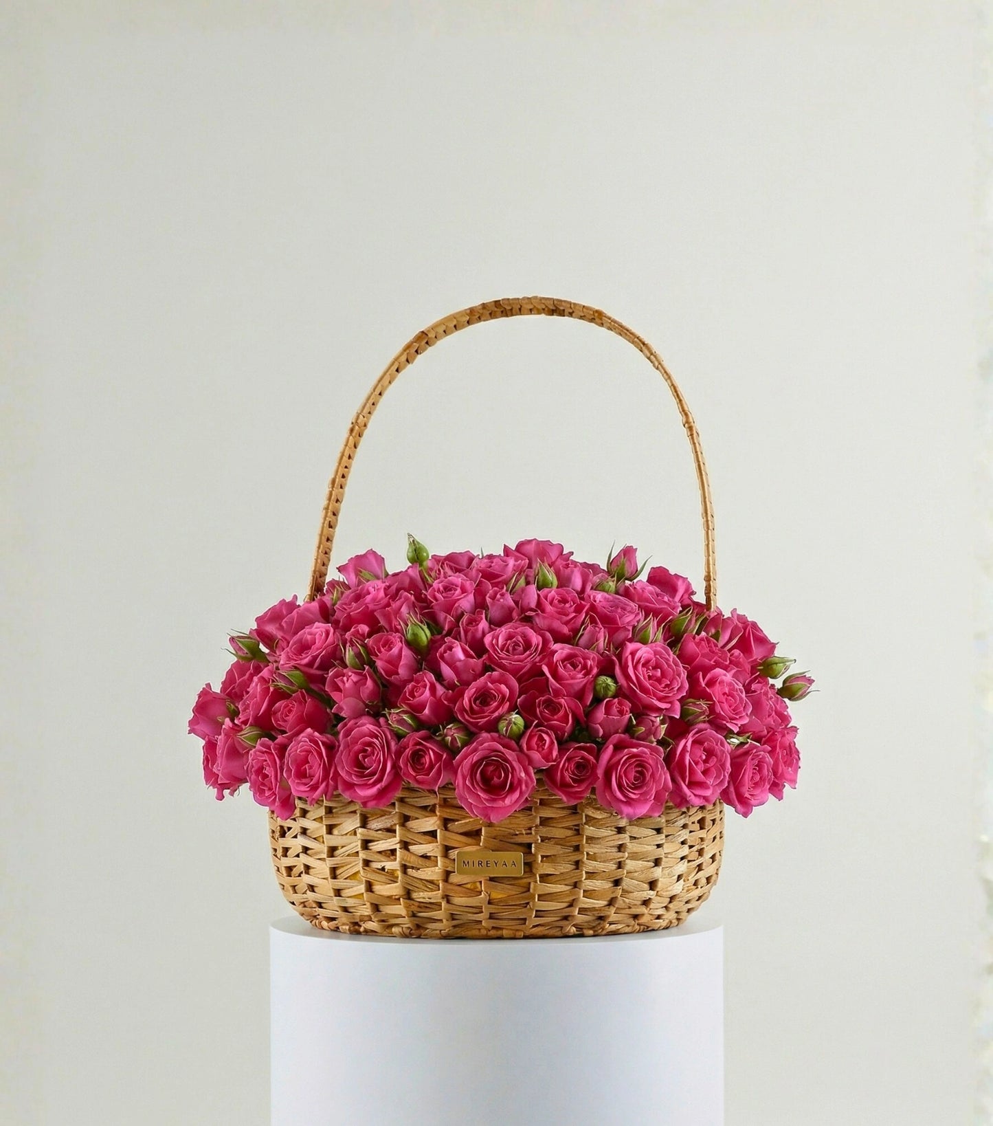 Deep pink roses in a water hyacinth estate basket — colour variant of The Grand Rose Estate Basket by Mireyaa