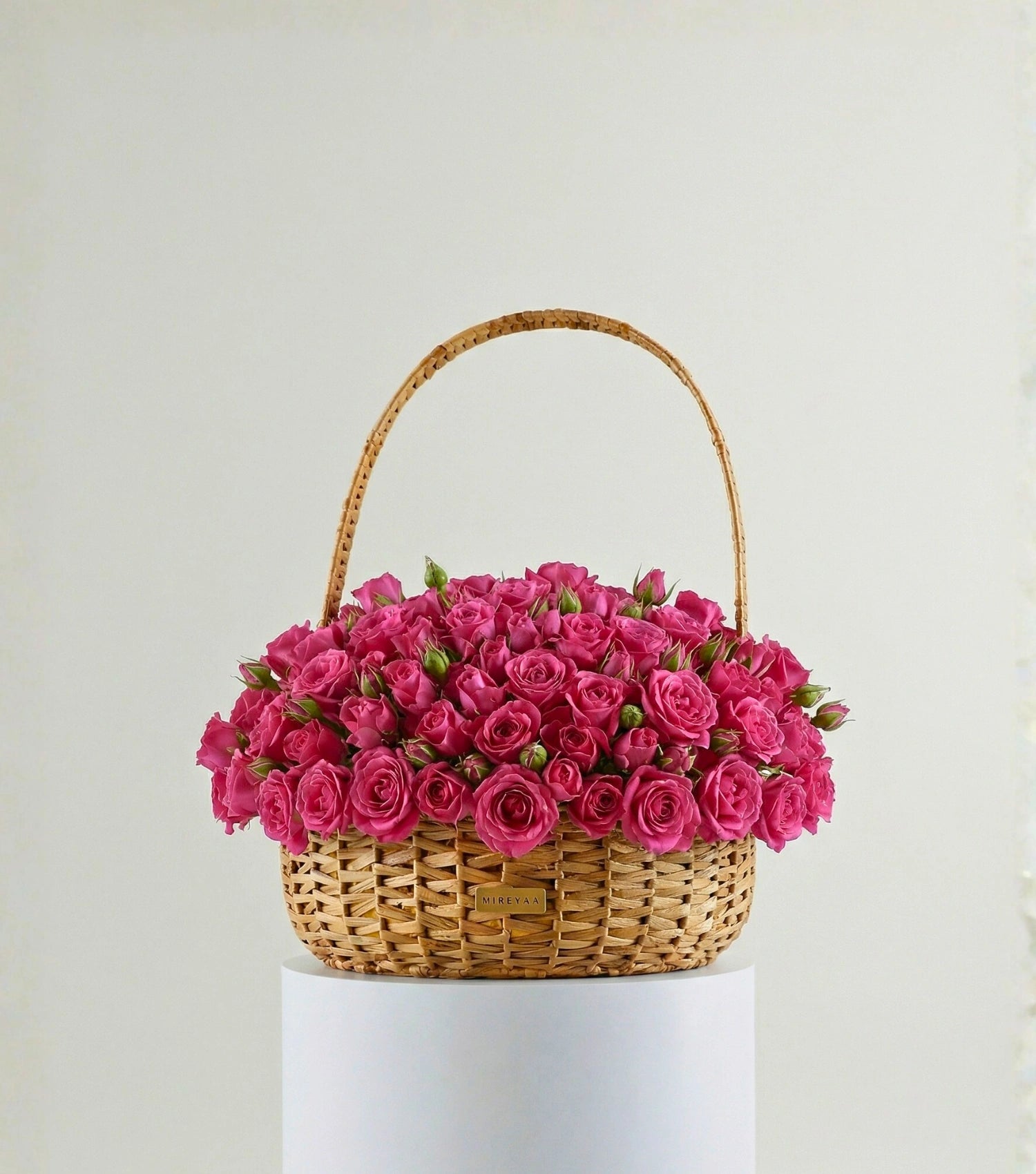 Deep pink roses in a water hyacinth estate basket — colour variant of The Grand Rose Estate Basket by Mireyaa
