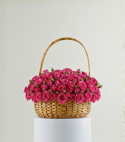 Deep pink roses in a water hyacinth estate basket — colour variant of The Grand Rose Estate Basket by Mireyaa