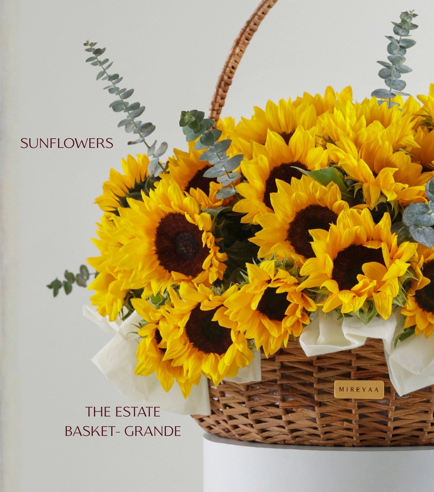 Close-up of Grande size sunflowers in a water hyacinth estate basket — The Sunfield Estate Basket by Mireyaa, Mumbai same-day delivery