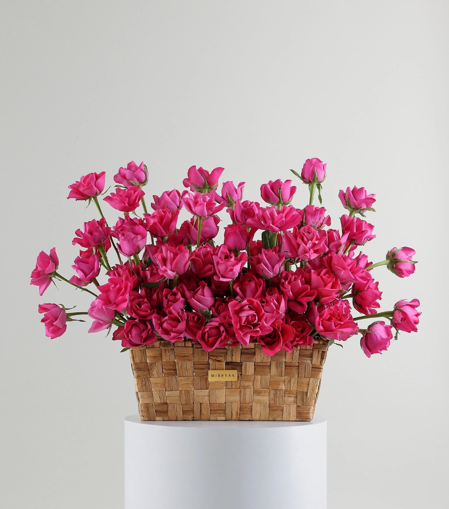 Front view of deep pink roses in a low rectangular basket — The Deep Rose Rectangular Basket by Mireyaa, Mumbai same-day delivery