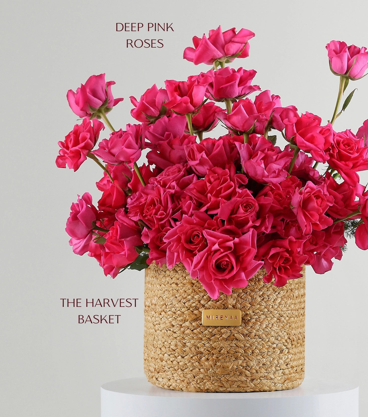 Close-up of crimson red roses in a handwoven jute harvest basket — The Sculpted Crimson Harvest Basket by Mireyaa, Mumbai same-day delivery