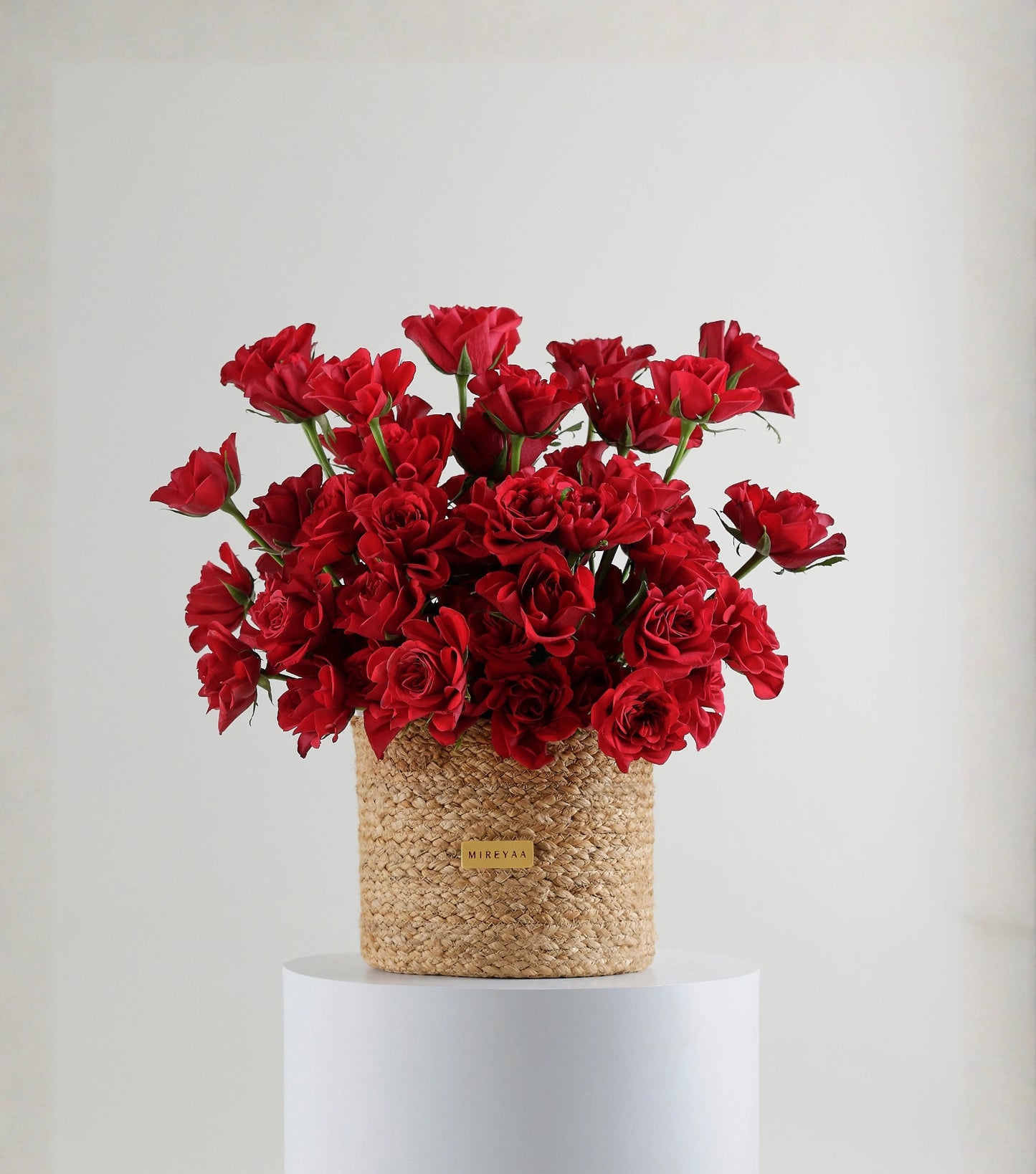 Front view of deep pink roses in a handwoven jute harvest basket — The Sculpted Rose Harvest Basket by Mireyaa, Mumbai same-day delivery