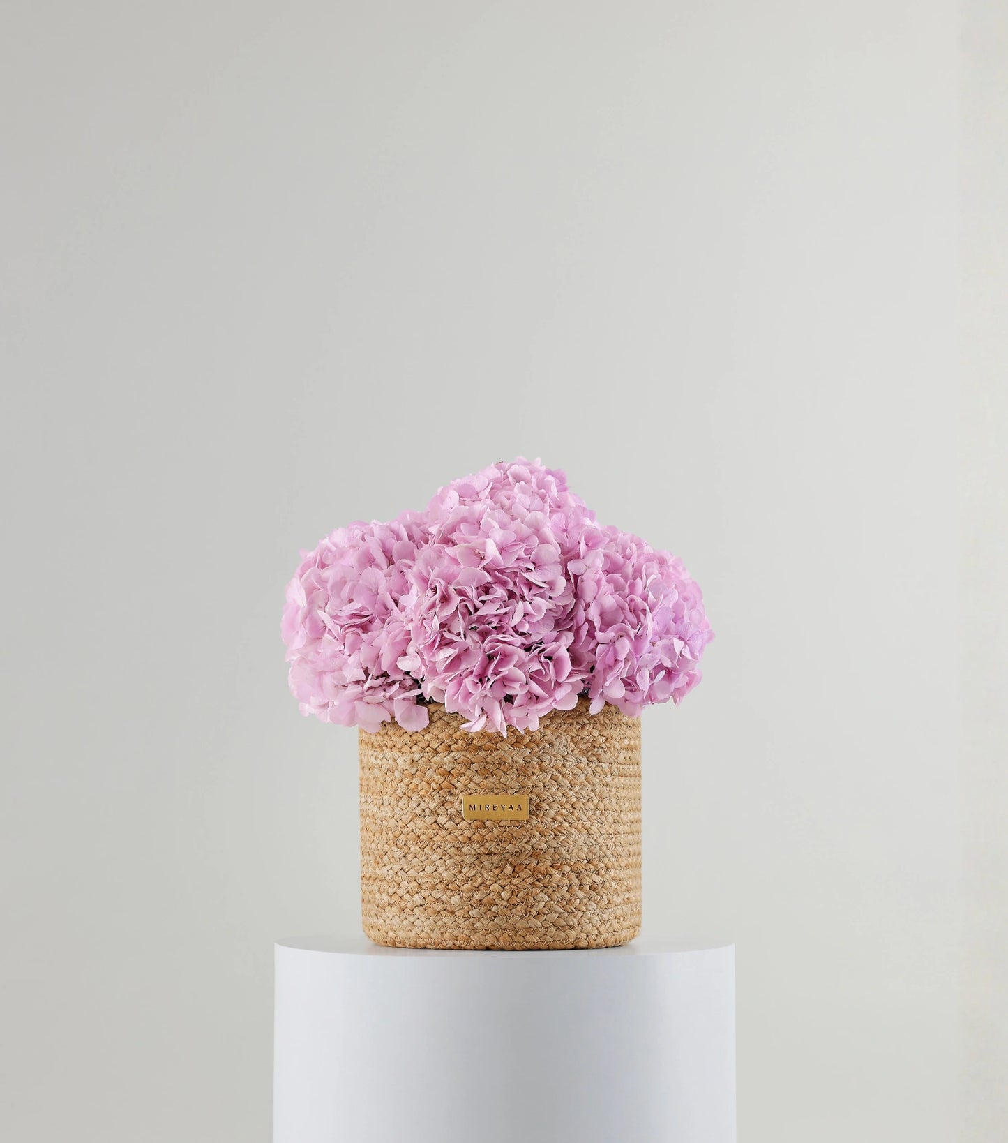 Front view of soft pink hydrangeas in a jute basket — variant of The Blue Hydrangea Harvest Basket by Mireyaa