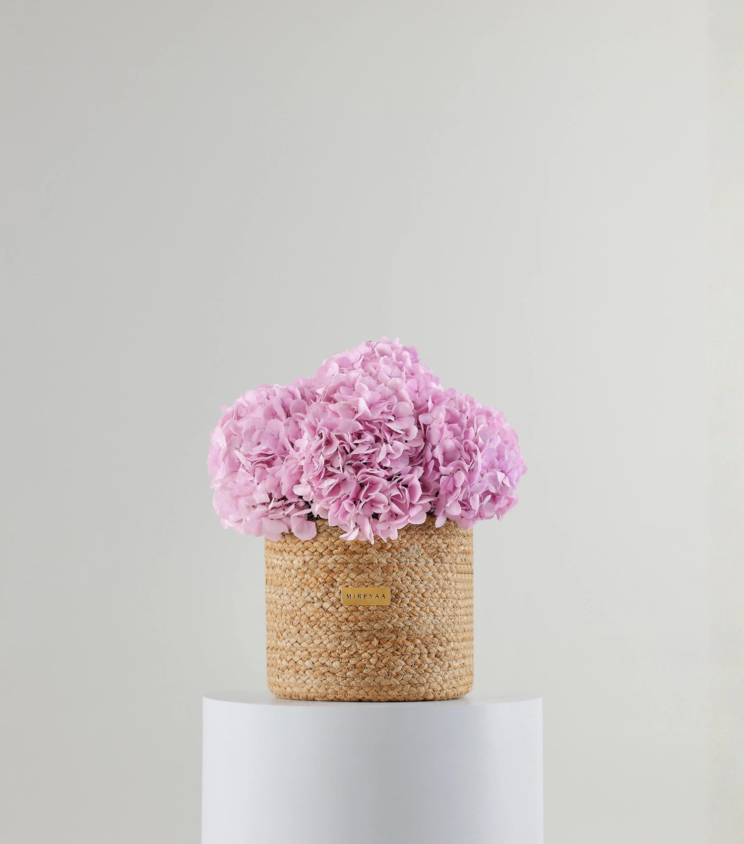 Front view of soft pink hydrangeas in a jute basket — variant of The Blue Hydrangea Harvest Basket by Mireyaa