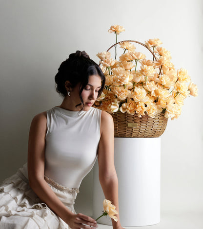 Side view of Grande size apricot roses in a water hyacinth estate basket — The Sculpted Rose Estate Basket by Mireyaa, Mumbai same-day delivery