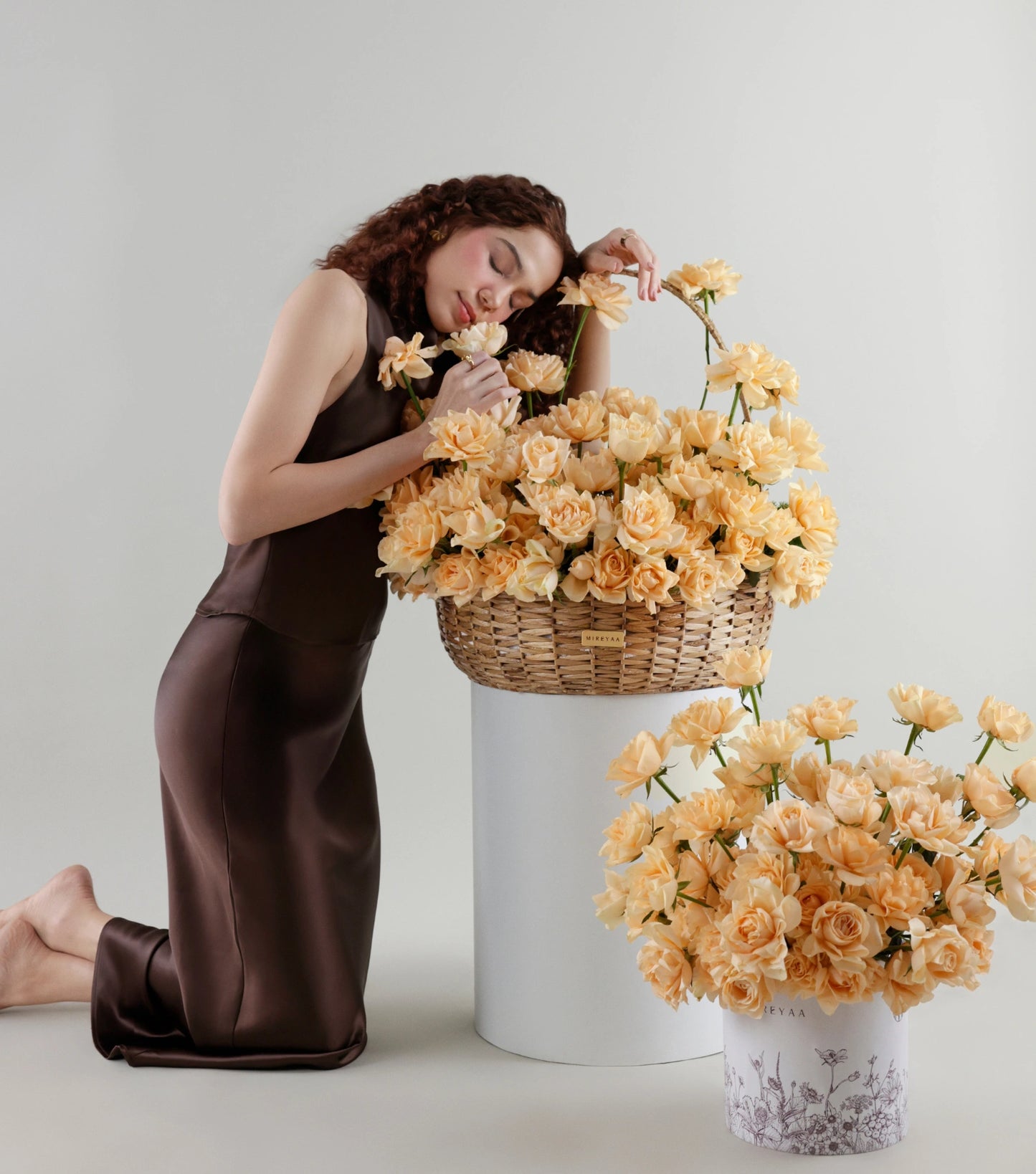 Hero shot of Grande size apricot roses in a water hyacinth estate basket — The Sculpted Rose Estate Basket by Mireyaa, Mumbai same-day delivery
