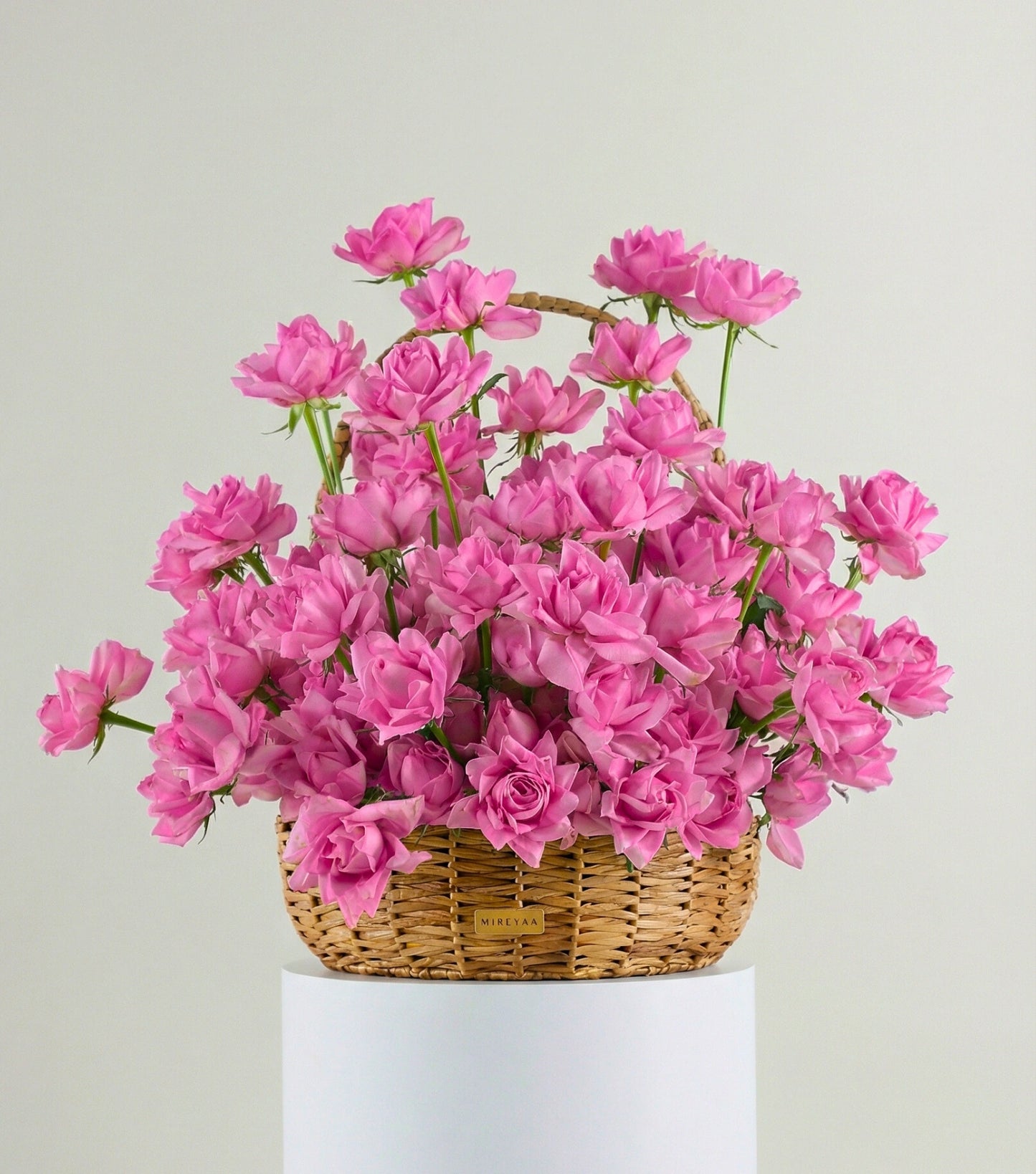 Front view of blush pink roses in a water hyacinth estate basket — The Sculpted Rose Estate Basket by Mireyaa, Mumbai same-day delivery