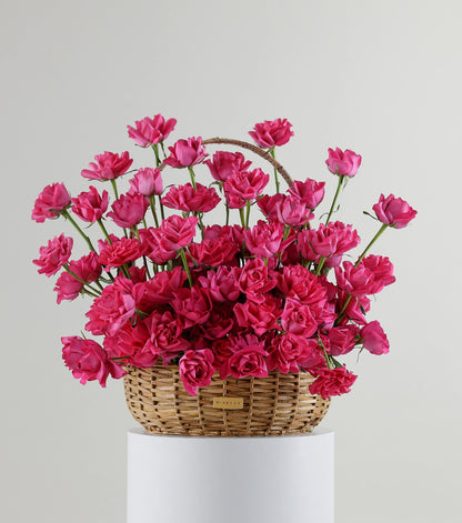 Front view of deep pink roses in a water hyacinth estate basket — The Sculpted Rose Estate Basket by Mireyaa, Mumbai same-day delivery