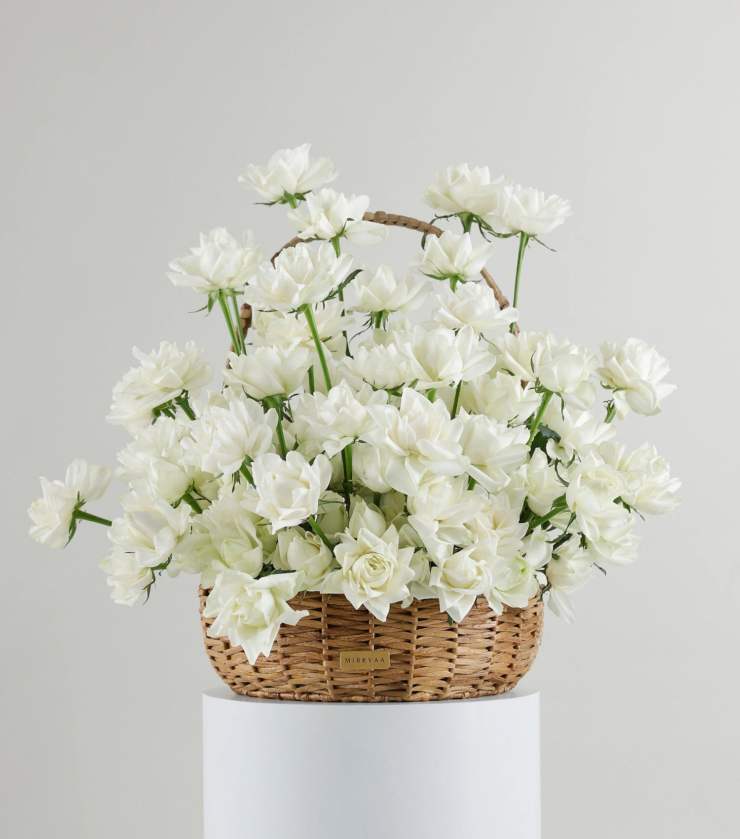 Front view of ivory white roses in a water hyacinth estate basket — The Sculpted Rose Estate Basket by Mireyaa, Mumbai same-day delivery