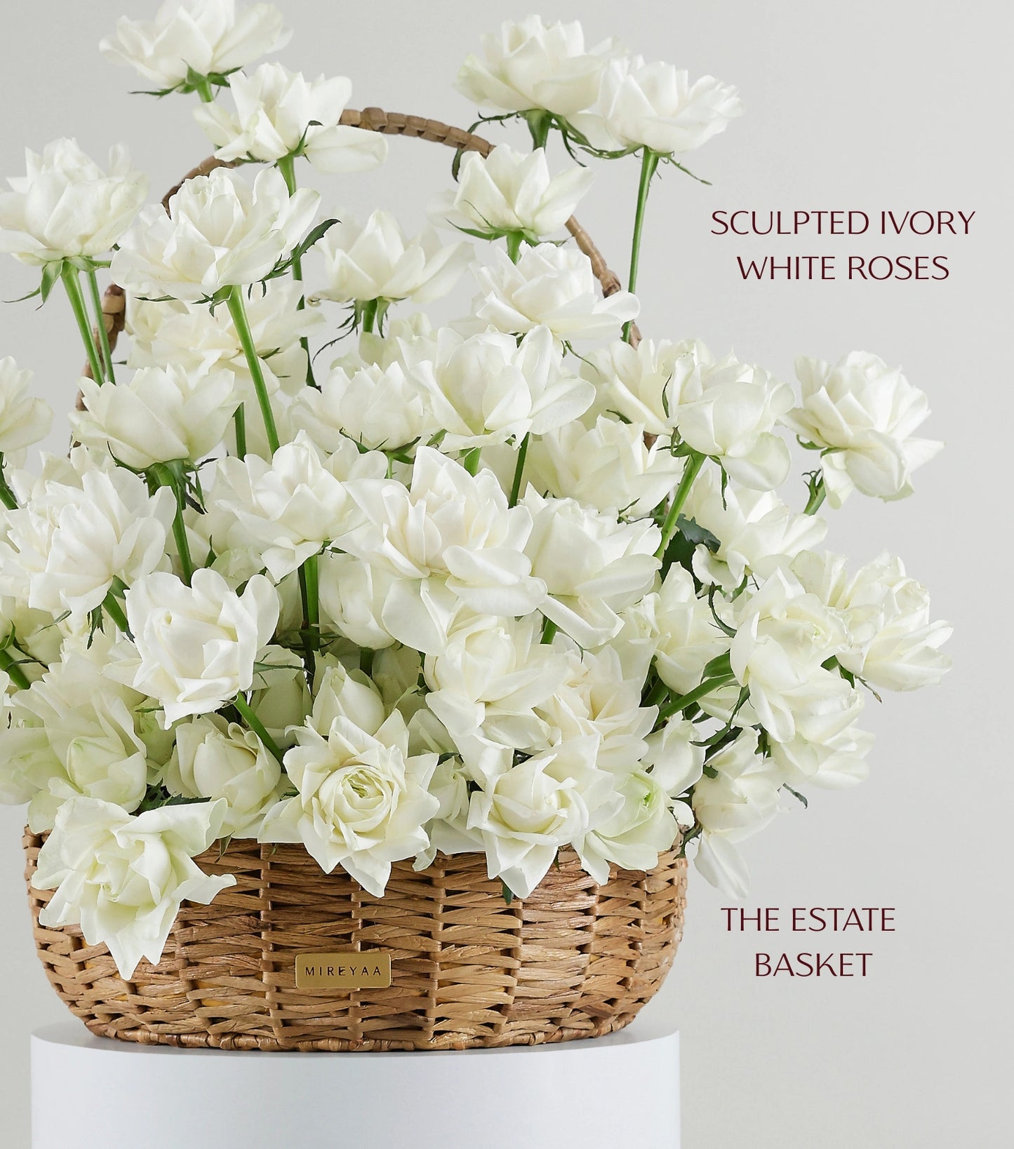 Close-up of ivory white roses in a water hyacinth estate basket — The Sculpted Rose Estate Basket by Mireyaa, Mumbai same-day delivery