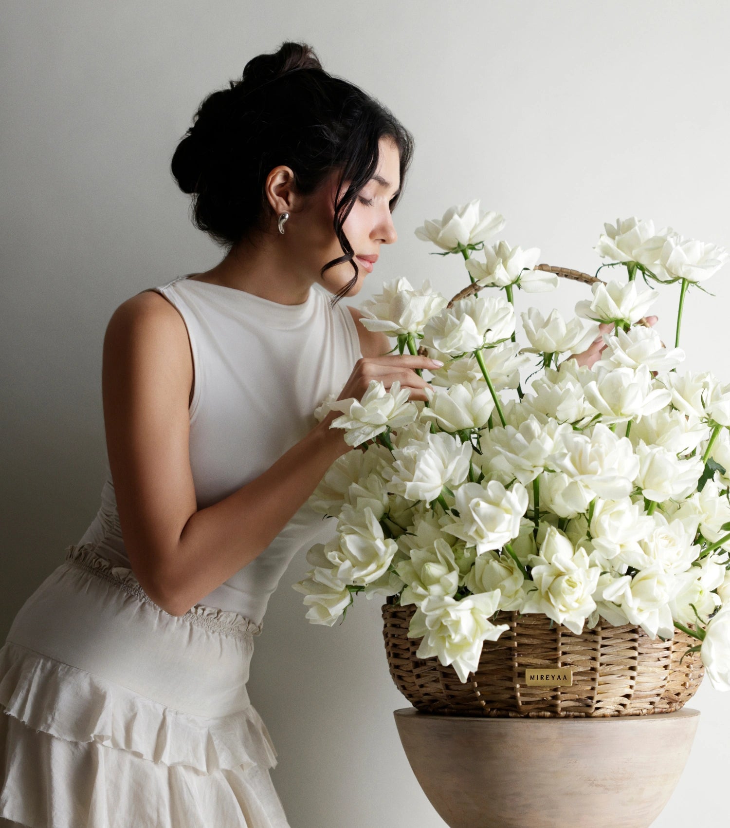 Side view of ivory white roses in a water hyacinth estate basket — The Sculpted Rose Estate Basket by Mireyaa, Mumbai same-day delivery