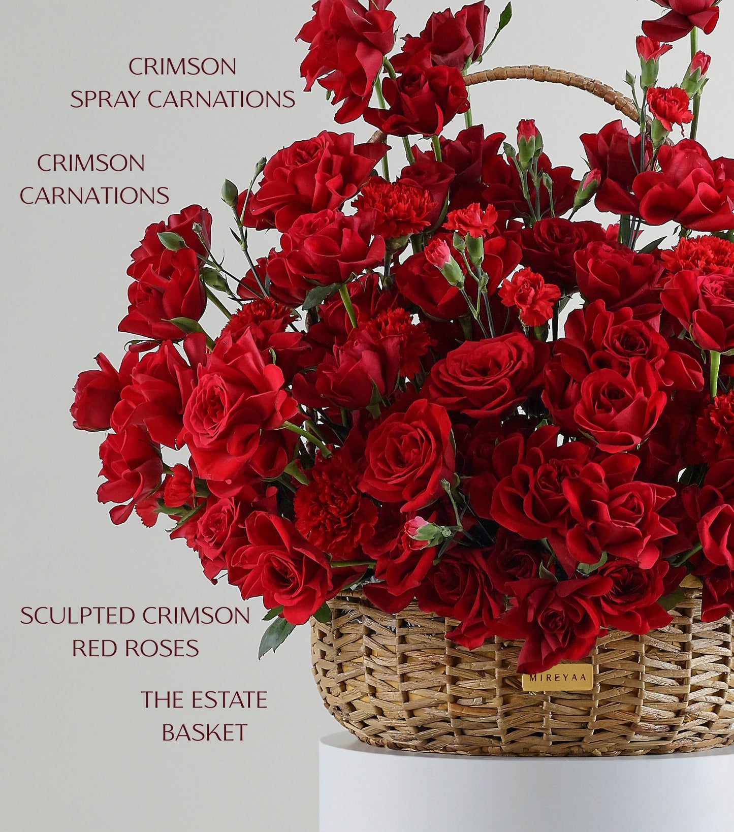 Close-up of crimson red roses in a water hyacinth estate basket — The Crimson Petal Estate Basket by Mireyaa, Mumbai same-day delivery